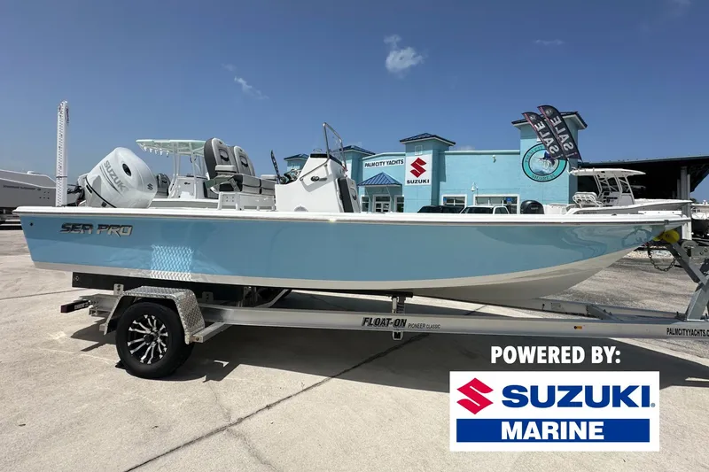 The Image of 2026 Sea Pro 230 Bay boat on trailer, powered by Suzuki Marine, at dealership. - 0