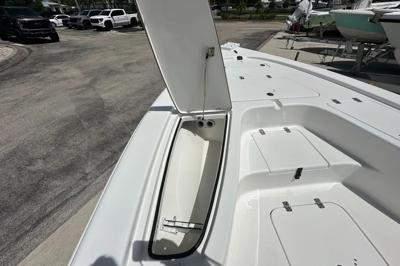 Slide: The Image of 2026 Sea Pro 230 Bay boat with open storage compartment on deck. - 6