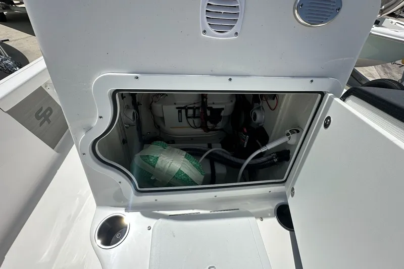 Slide: The Image of Open storage compartment on a 2026 Sea Pro 230 Bay boat, showing internal components. - 12