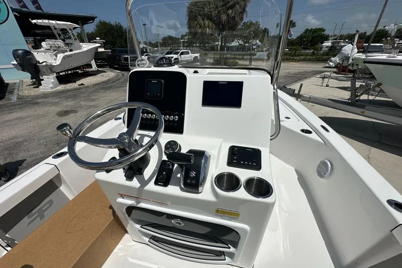 Slide: The Image of 2026 Sea Pro 230 Bay boat console with steering wheel and navigation controls. - 4