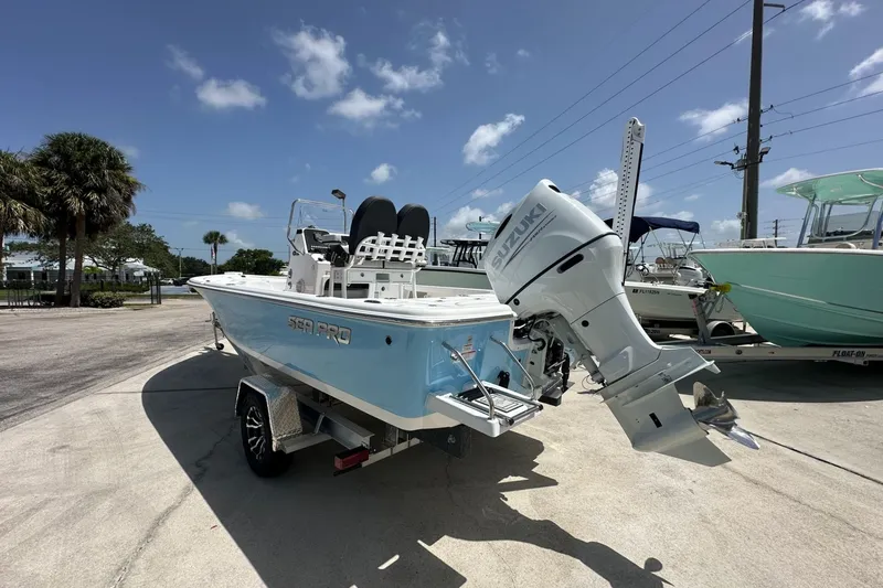 Slide: The Image of 2026 Sea Pro 230 Bay boat with Suzuki outboard motor on a sunny day. - 2