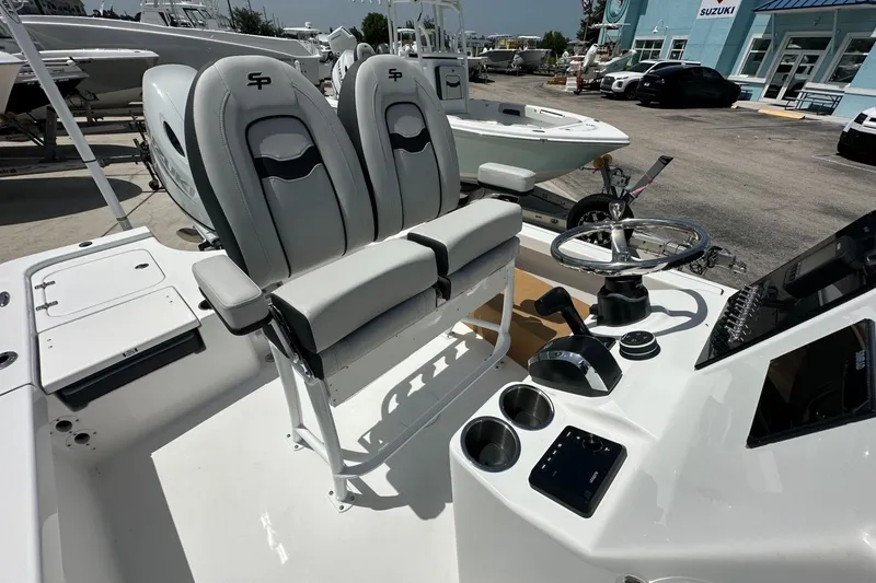 Slide: The Image of 2026 Sea Pro 230 Bay boat interior with dual seats and steering console. - 13