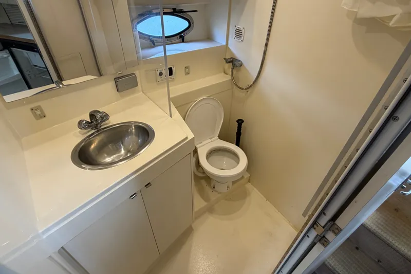 Slide: The Image of Bathroom interior of 1996 Carver 325 Aft Cabin Motor Yacht, featuring sink and toilet. - 20