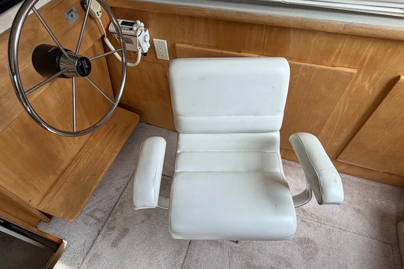 Slide: The Image of Captain's chair and steering wheel in 1996 Carver 325 Aft Cabin Motor Yacht. - 26