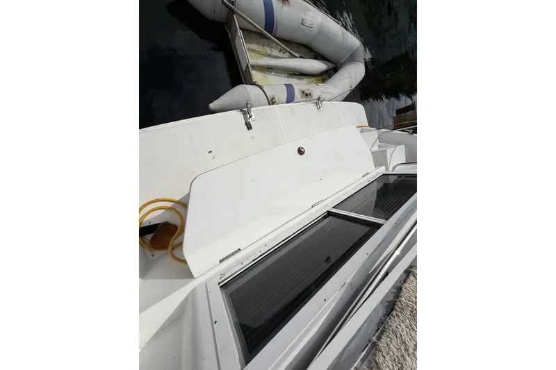 Slide: The Image of 1996 Carver 325 Aft Cabin Motor Yacht deck with inflatable boat nearby. - 33
