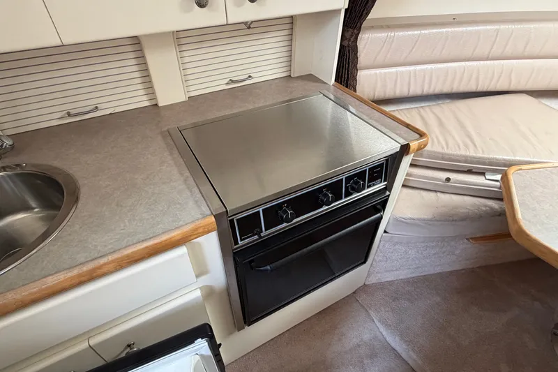 Slide: The Image of Compact kitchen area in a 1996 Carver 325 Aft Cabin Motor Yacht. - 17