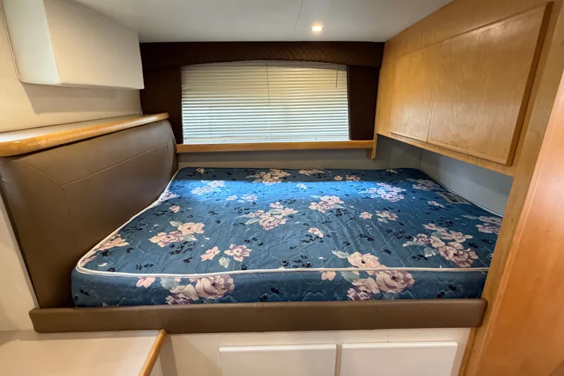 Slide: The Image of Cozy bedroom in 1996 Carver 325 Aft Cabin Motor Yacht with floral mattress. - 31