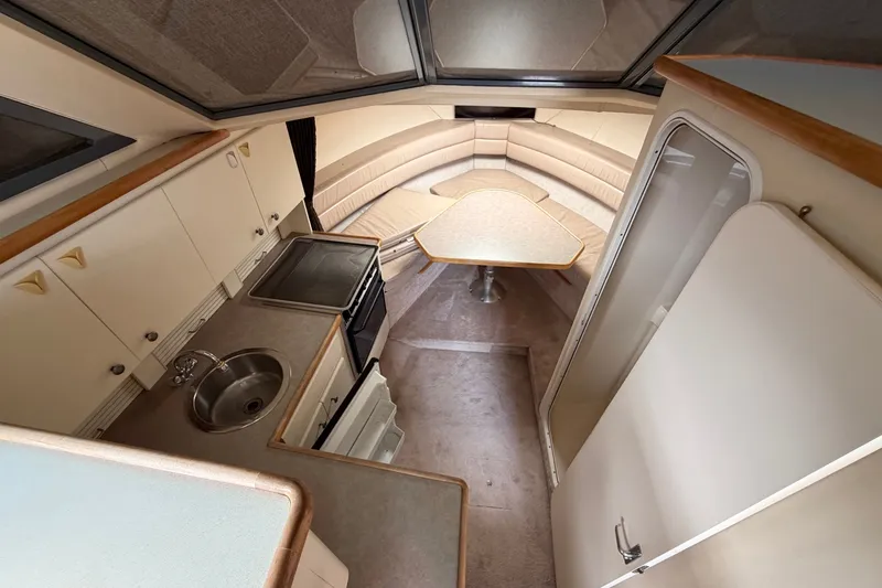 Slide: The Image of Interior of 1996 Carver 325 Aft Cabin Motor Yacht with kitchen and seating area. - 15