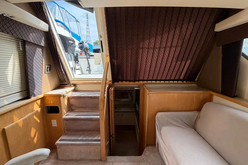 Slide: The Image of Interior of 1996 Carver 325 Aft Cabin Motor Yacht with stairs and seating area. - 28