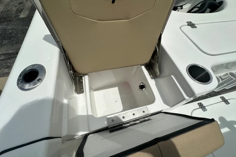 Slide: The Image of 2027 Sea Pro 230 Bay boat interior storage compartment with cup holders and seating. - 14