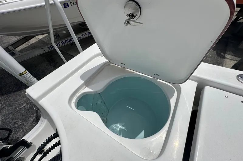Slide: The Image of Open storage compartment on a 2027 Sea Pro 230 Bay boat, showcasing interior space. - 16