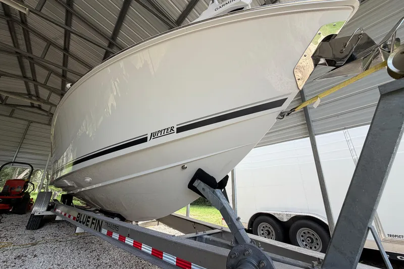 Slide: The Image of 2019 Jupiter 30 boat on Blue Fin trailer under metal shelter. - 12