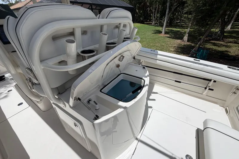 Slide: The Image of 2019 Jupiter 30 boat interior with open storage compartment and cup holders. - 36