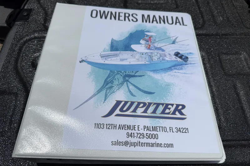 Slide: The Image of Owner's manual for 2019 Jupiter 30 boat, featuring contact details and illustration. - 48