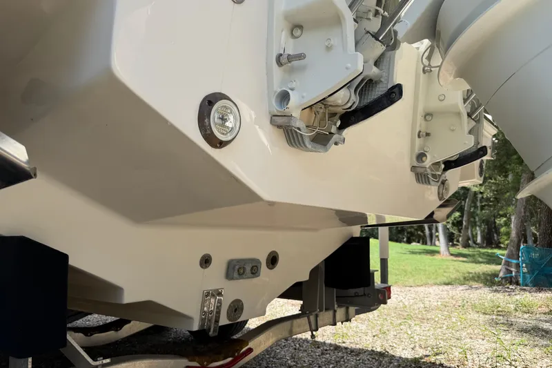 Slide: The Image of Rear view of a 2019 Jupiter 30 boat on a trailer, showcasing engine mounts. - 9