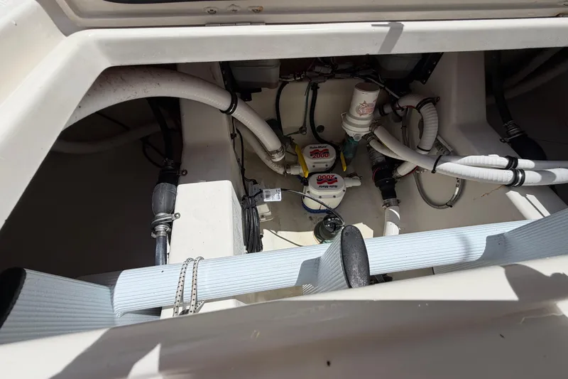 Slide: The Image of Engine compartment of a 2019 Jupiter 30 boat, showcasing hoses and mechanical components. - 41