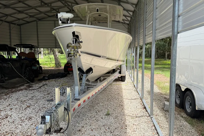 Slide: The Image of 2019 Jupiter 30 boat on trailer in covered storage area. - 13
