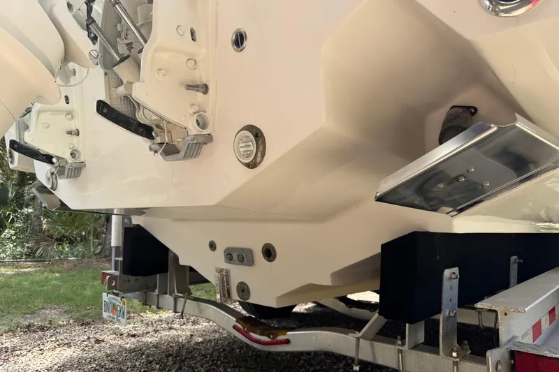 Slide: The Image of Rear view of a 2019 Jupiter 30 boat on a trailer, showing engine mounts. - 10