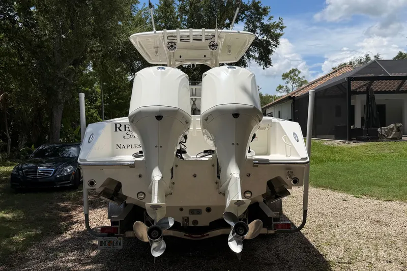 Slide: The Image of Rear view of a 2019 Jupiter 30 boat with dual outboard motors. - 8