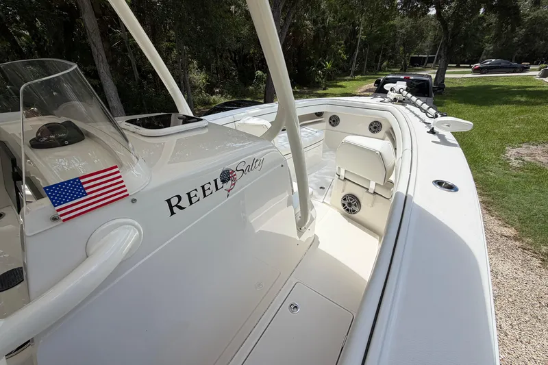 Slide: The Image of 2019 Jupiter 30 boat with "Reel Salty" name, American flag, and fishing rod holders. - 25