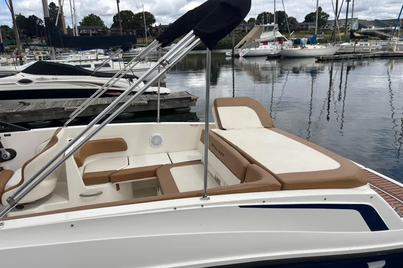 Slide: The Image of 2021 Bayliner VR6 Bowrider I/O docked at marina, featuring spacious seating and sleek design. - 6