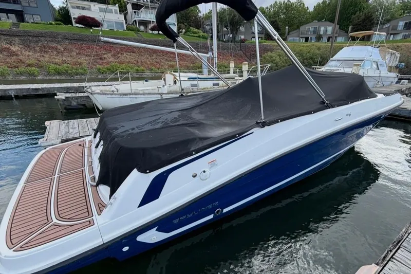 Slide: The Image of 2021 Bayliner VR6 Bowrider I/O covered at a marina dock. - 16
