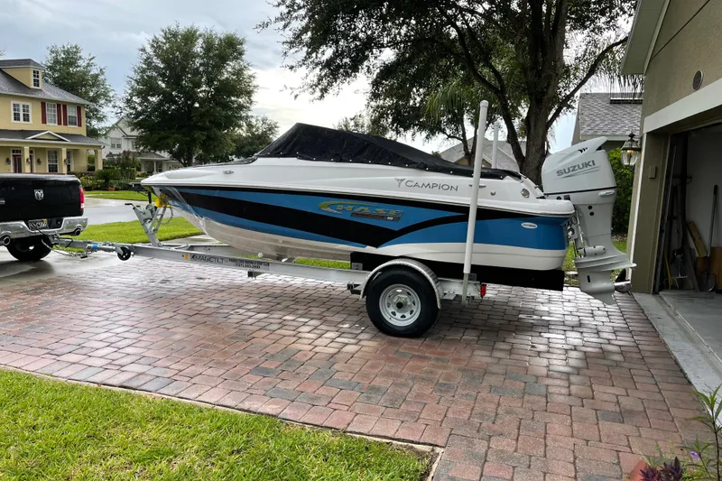 Slide: The Image of 2021 Campion Allante 180 boat on trailer, parked in residential driveway. - 2