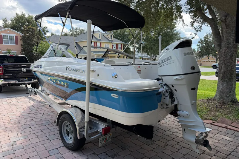 Slide: The Image of 2021 Campion Allante 180 boat with Suzuki 140 engine on a trailer in a driveway. - 7