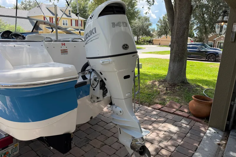 Slide: The Image of 2021 Campion Allante 180 boat with Suzuki 140 outboard motor in a residential driveway. - 9