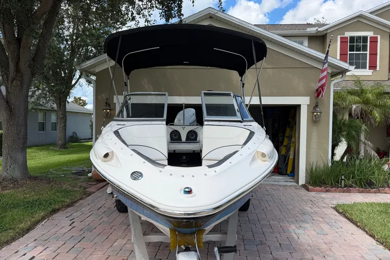 Slide: The Image of 2021 Campion Allante 180 boat parked in driveway, front view with canopy. - 2