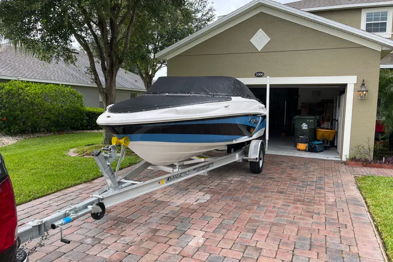 Slide: The Image of 2021 Campion Allante 180 boat on trailer in driveway, covered and ready for transport. - 3