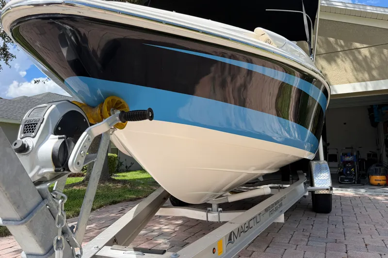 Slide: The Image of 2021 Campion Allante 180 boat on trailer, parked in driveway, close-up view. - 11