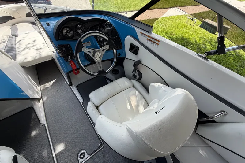 Slide: The Image of Interior of a 2021 Campion Allante 180 boat with steering wheel and seating. - 15