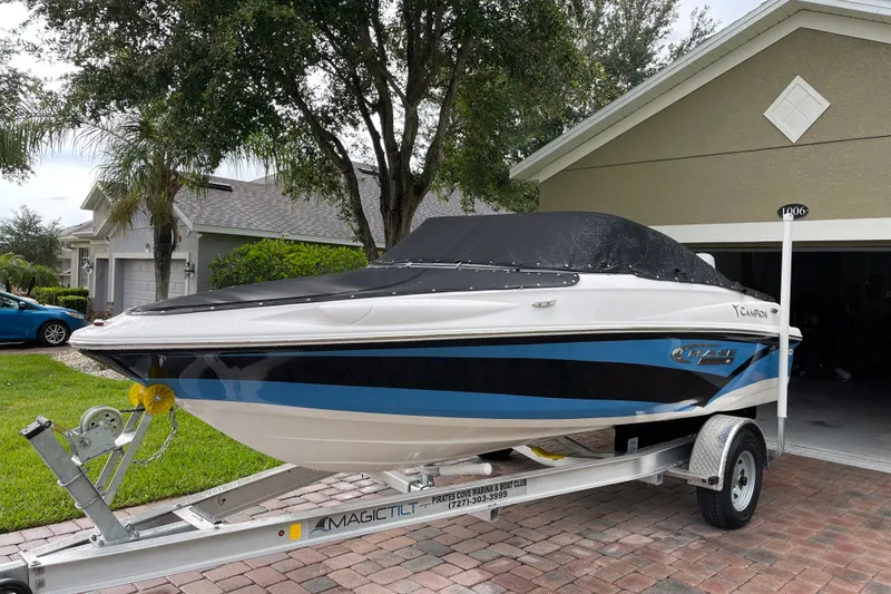 Slide: The Image of 2021 Campion Allante 180 boat on trailer, parked in a residential driveway. - 0