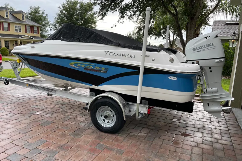 Slide: The Image of 2021 Campion Allante 180 boat with Suzuki engine on trailer, parked on brick driveway. - 1