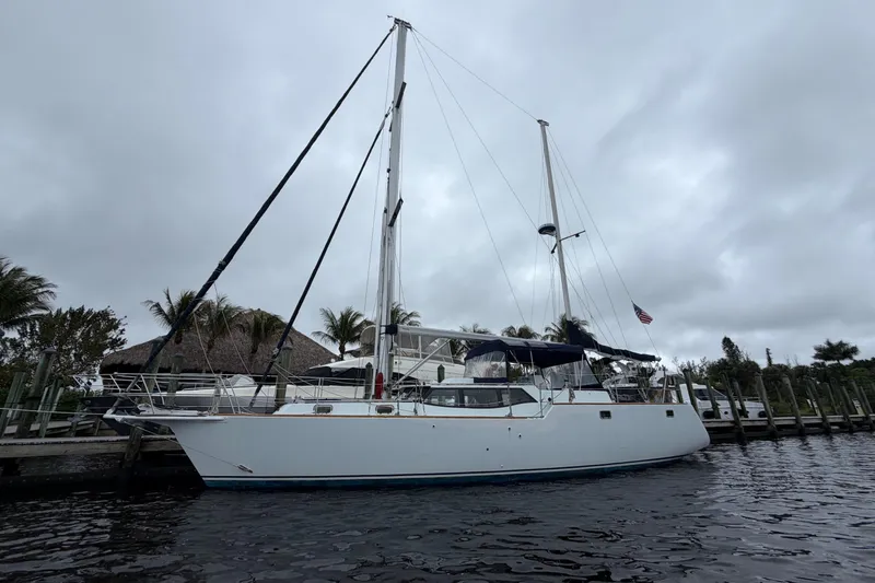 Slide: The Image of Custom Build 50' Ketch, 2011, docked under cloudy skies, side view. - 2