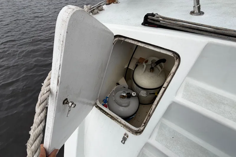 Slide: The Image of Open hatch on 2011 Custom Build 50' Ketch, revealing propane tanks inside. - 5