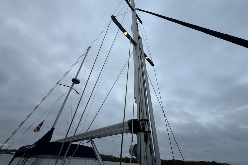 Slide: The Image of Mast and rigging of a 2011 Custom Build 50' Ketch against a cloudy sky. - 17