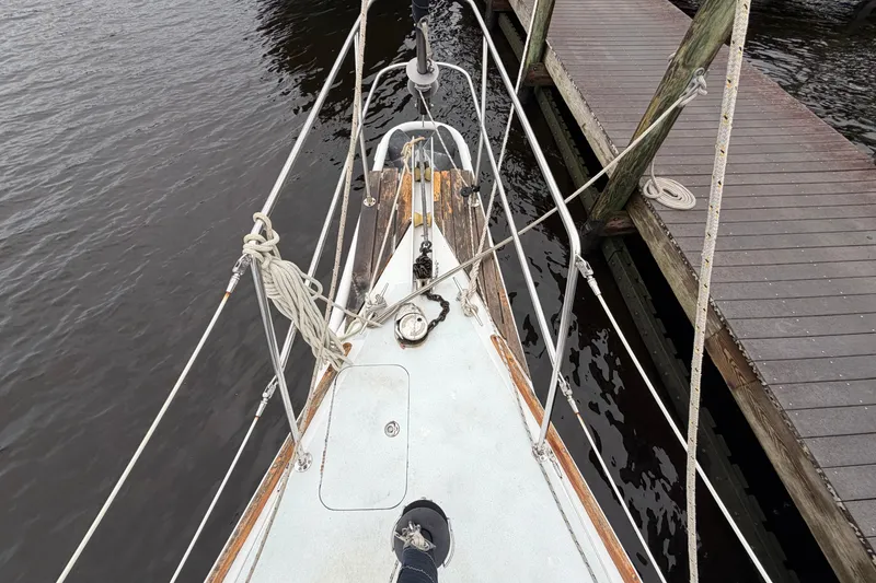 Slide: The Image of Bow view of a 2011 Custom Build 50' Ketch, docked beside a wooden pier. - 13