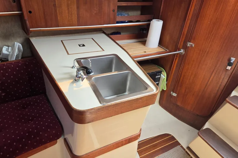 Slide: The Image of Interior of 1989 Ericson Olsen 34 sailboat featuring a compact kitchen area. - 6