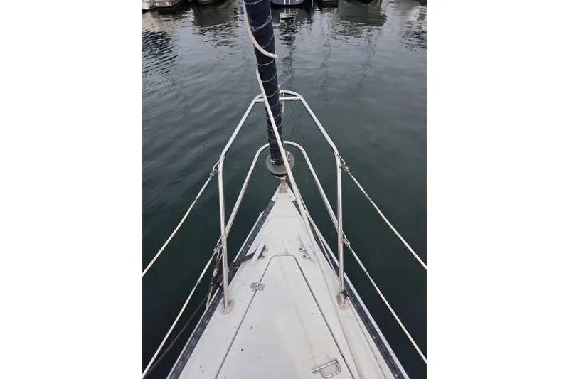 The Image of Bow view of 1989 Ericson Olsen 34 sailboat docked in calm waters. - 1