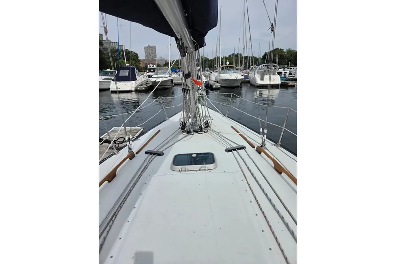 Slide: The Image of Ericson Olsen 34 sailboat deck view, docked in a marina, 1989 model. - 2