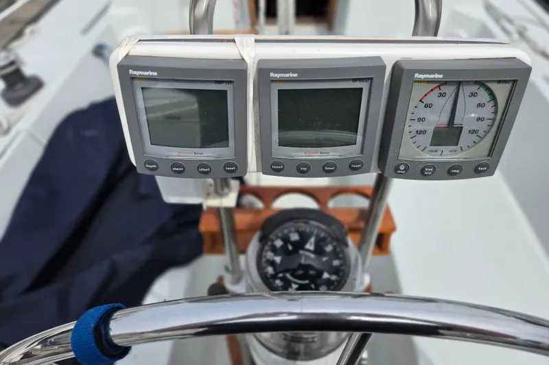 Slide: The Image of Cockpit instruments on a 1989 Ericson Olsen 34 sailboat, featuring Raymarine displays. - 12