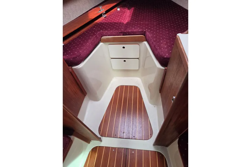 Slide: The Image of Interior of 1989 Ericson Olsen 34 sailboat with wood flooring and maroon upholstery. - 3