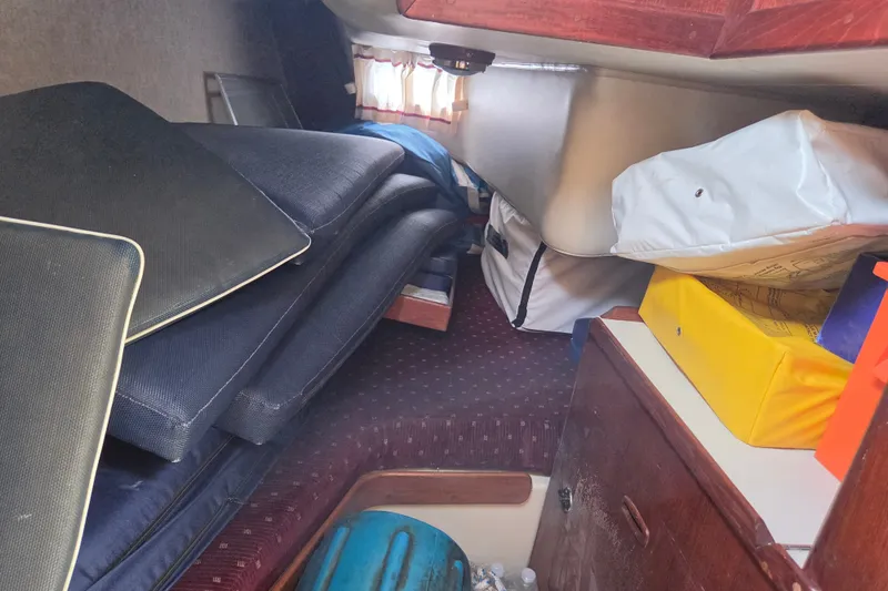 Slide: The Image of Interior cabin of 1989 Ericson Olsen 34 sailboat with cushions and storage bags. - 7