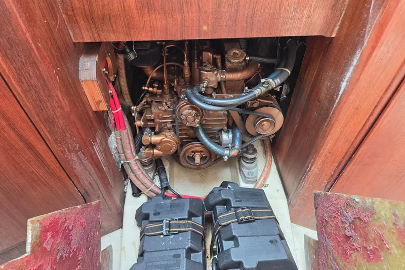Slide: The Image of Engine compartment of a 1989 Ericson Olsen 34 sailboat, featuring visible mechanical components. - 9