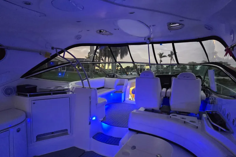 Slide: The Image of Luxurious 2006 Cruisers Yachts 520 Express interior with ambient blue lighting at sunset. - 22