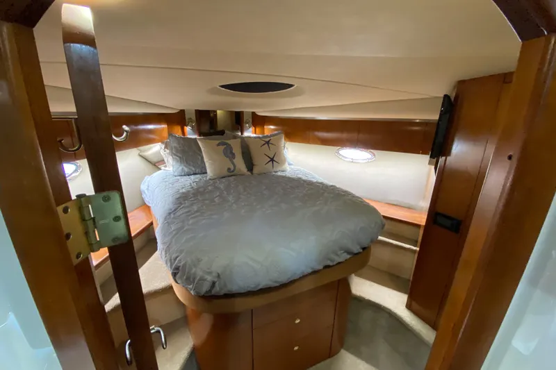 Slide: The Image of Luxurious 2006 Cruisers Yachts 520 Express cabin interior with cozy bed and elegant wood finish. - 80