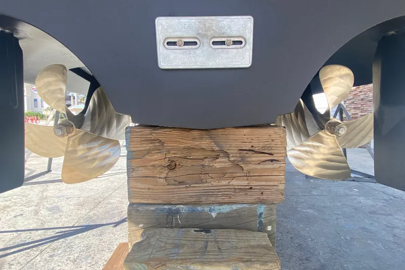 Slide: The Image of 2006 Cruisers Yachts 520 Express propellers and hull on wooden blocks. - 43