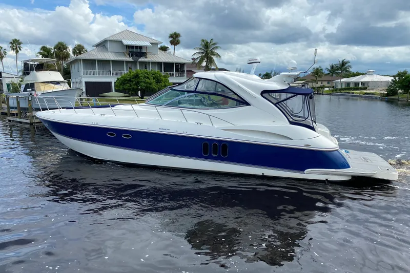 Slide: The Image of 2006 Cruisers Yachts 520 Express on water, featuring sleek design and blue accents. - 4